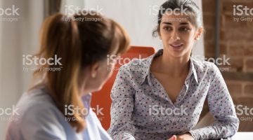 istockphoto-1139873768-2048×2048 Indian businesswoman speaking to colleague or hr during job interview, young professional hindu woman manager consulting client or explaining giving advice teaching at business office meeting